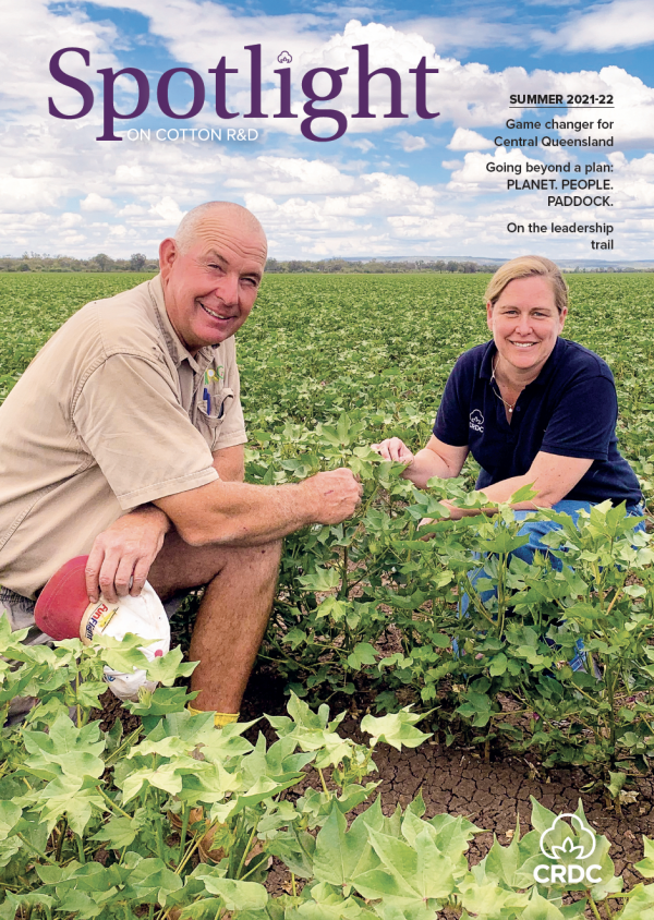 Cover image of the CRDC Spotlight magazine Summer 2021-22. Two people kneeling in a cotton paddock.