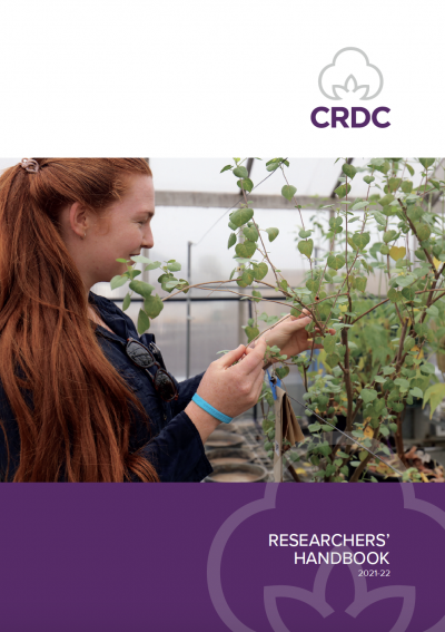 Cover image of the CRDC Researchers Handbook. Researcher in glasshouse with cotton plant. 
