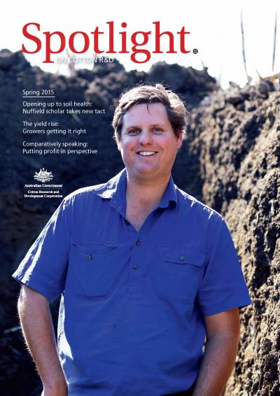 Cover of Spotlight Magazine - Spring 2015. A cotton grower in a blue shirt standing inside a soil pit. 