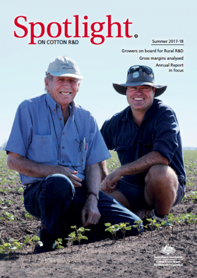 Cover of Spotlight Magazine - Summer 2017-18. Two cotton growers kneeling in a cotton paddock with small cotton seedlings. 
